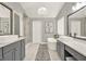 Elegant bathroom featuring dual vanities, a soaking tub, a walk-in shower, and stylish finishes at 6675 Flagstone Ct, Cumming, GA 30028