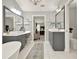 Elegant bathroom featuring dual vanities, a soaking tub, and stylish finishes at 6675 Flagstone Ct, Cumming, GA 30028