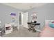 Well-lit bedroom featuring a desk, piano, neutral walls, and plush carpet at 6675 Flagstone Ct, Cumming, GA 30028