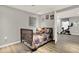 Bedroom with a bed and open french doors leading to another room with an exercise bike at 6675 Flagstone Ct, Cumming, GA 30028