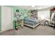 Green room featuring a bed with a green color scheme, plenty of décor, and natural lighting at 6675 Flagstone Ct, Cumming, GA 30028