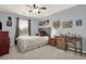 A cozy bedroom with dark accents, sports decor, plush carpet, and natural light at 6675 Flagstone Ct, Cumming, GA 30028