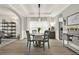 Charming dining room with modern lighting, hardwood floors, and comfortable seating, perfect for entertaining at 6675 Flagstone Ct, Cumming, GA 30028