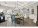 Elegant dining room with tray ceilings, hardwood floors, and stylish decor, ideal for Gathering gatherings at 6675 Flagstone Ct, Cumming, GA 30028