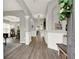 Bright and airy foyer with hardwood floors, elegant archways, and modern lighting fixtures at 6675 Flagstone Ct, Cumming, GA 30028