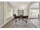 Bright home office with large windows, modern desk, and neutral decor, ideal for productivity at 6675 Flagstone Ct, Cumming, GA 30028