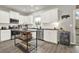 Bright kitchen features white cabinets, stainless steel appliances, dark countertops, and kitchen island at 6675 Flagstone Ct, Cumming, GA 30028