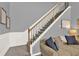 Living room featuring a staircase with wrought iron spindles and neutral decor at 6675 Flagstone Ct, Cumming, GA 30028