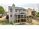 Rear exterior featuring a screened porch and outdoor living space at 6675 Flagstone Ct, Cumming, GA 30028