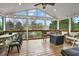 Relaxing screened porch with dining and lounge area offering a great outdoor view at 6675 Flagstone Ct, Cumming, GA 30028