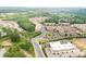 Aerial view of community featuring residential buildings, commercial spaces, and green areas at 2940 W Village Dr # 60, Suwanee, GA 30024