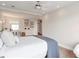 Bright bedroom with a white bed, ceiling fan, vanity, and soft decor for a relaxing space at 2940 W Village Dr # 60, Suwanee, GA 30024