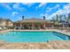 Refreshing community pool surrounded by comfortable seating and lush greenery at 2940 W Village Dr # 60, Suwanee, GA 30024