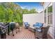 Cozy outdoor deck area with comfortable seating, grill, and decorative string lights at 2940 W Village Dr # 60, Suwanee, GA 30024