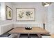 Dining area with a wooden table, cushioned seating and artistic wall decor at 2940 W Village Dr # 60, Suwanee, GA 30024