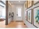 Bright entryway with hardwood floors, decorative mirror, and artwork creating a stylish first impression at 2940 W Village Dr # 60, Suwanee, GA 30024