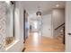 Inviting hallway with wood floors, water feature accent, and stylish lighting leading to various rooms at 2940 W Village Dr # 60, Suwanee, GA 30024