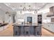 Gourmet kitchen with a large island, stainless appliances, and modern lighting at 2940 W Village Dr # 60, Suwanee, GA 30024