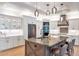 Bright kitchen with custom cabinetry, stainless steel appliances and large island at 2940 W Village Dr # 60, Suwanee, GA 30024