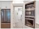 Modern kitchen showing stainless refrigerator and view to the laundry room at 2940 W Village Dr # 60, Suwanee, GA 30024
