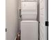 Efficient laundry area featuring a stacked washer and dryer in a neutral color scheme at 2940 W Village Dr # 60, Suwanee, GA 30024