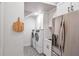 Cozy laundry room with washer, dryer, built-in cabinets and access to kitchen at 2940 W Village Dr # 60, Suwanee, GA 30024