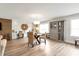 Open living room featuring light wood floors, modern lighting, built-in shelving and desk spaces at 2940 W Village Dr # 60, Suwanee, GA 30024