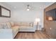 Comfortable living room with a beige sectional sofa, wood accent wall, and modern decor at 2940 W Village Dr # 60, Suwanee, GA 30024