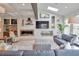 Bright living room with a bar area, modern fireplace, large windows, comfortable seating, and hardwood floors at 2940 W Village Dr # 60, Suwanee, GA 30024
