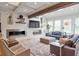 Bright living room with coffered ceilings, wooden beam, modern fireplace, large windows and comfortable seating at 2940 W Village Dr # 60, Suwanee, GA 30024
