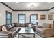 A comfortable living room with a large leather sectional sofa and neutral color palette at 2940 W Village Dr # 60, Suwanee, GA 30024