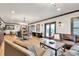 Spacious living area with ample seating, including a leather sofa and desk space at 2940 W Village Dr # 60, Suwanee, GA 30024