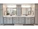 Large main bathroom with double sinks and large mirrors in a neutral color palette at 2940 W Village Dr # 60, Suwanee, GA 30024