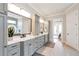 Open-concept bathroom with dual sinks, modern fixtures, tiled floors and open view to shower at 2940 W Village Dr # 60, Suwanee, GA 30024