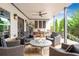 Comfortable outdoor patio featuring ceiling fan, dining, and seating with views of a landscaped backyard at 2940 W Village Dr # 60, Suwanee, GA 30024
