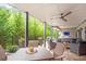 Spacious outdoor patio with ceiling fan and outdoor seating and dining area with views of the landscaped backyard at 2940 W Village Dr # 60, Suwanee, GA 30024