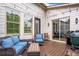 Inviting outdoor patio featuring comfortable seating, string lights, and a grill for entertaining at 2940 W Village Dr # 60, Suwanee, GA 30024