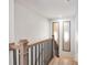 Elegant staircase with wood treads, iron balusters, and stylish wall sconces at 2940 W Village Dr # 60, Suwanee, GA 30024