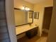 Bathroom vanity featuring a long counter, a sink, a mirror, and cabinet storage at 3011 Canyon Point Cir, Roswell, GA 30076