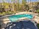 Community in-ground pool surrounded by mature trees, fencing, and a sunning deck at 3011 Canyon Point Cir, Roswell, GA 30076