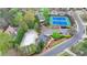 Aerial view of community amenities: a pool, clubhouse, tennis courts, and playground at 10460 Cranchester Way, Alpharetta, GA 30022