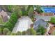 Aerial view of community pool and amenity area including playground, tennis and basketball courts surrounded by mature trees at 10460 Cranchester Way, Alpharetta, GA 30022