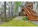Home exterior features a wooden staircase leading to a deck and a fenced in yard at 10460 Cranchester Way, Alpharetta, GA 30022