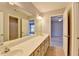 Large bathroom vanity with a long mirror and double sinks, with doorways leading to other rooms at 10460 Cranchester Way, Alpharetta, GA 30022