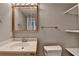 Bathroom features a vanity with a white sink, a mirrored medicine cabinet, and open shelving at 10460 Cranchester Way, Alpharetta, GA 30022