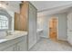 Bathroom with custom cabinetry, double vanity, tile flooring, and soaking tub at 10460 Cranchester Way, Alpharetta, GA 30022
