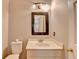 Cozy bathroom with toilet, sink, mirror, and neutral wall color scheme at 10460 Cranchester Way, Alpharetta, GA 30022
