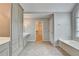 Bathroom with custom cabinetry, double vanity, tile flooring, and soaking tub at 10460 Cranchester Way, Alpharetta, GA 30022