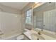 Well-maintained bathroom features a tub with white tile surround and a large mirror at 10460 Cranchester Way, Alpharetta, GA 30022