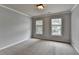 Bedroom featuring two windows allowing for natural light at 10460 Cranchester Way, Alpharetta, GA 30022